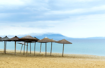 Sun loungers with an umbrella morning on the beach scene