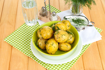 Boiled potatoes on platens on on napkins on wooden table