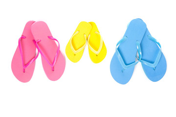 three pairs of flip flops on white