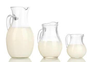 Milk in jugs isolated on white