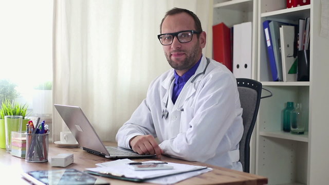 Friendly, happy male doctor in the office