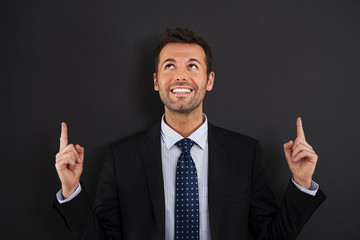 Businessman pointing up on copy space