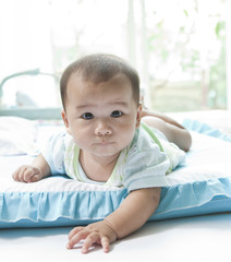 Fototapeta premium close up face of baby lying on bed