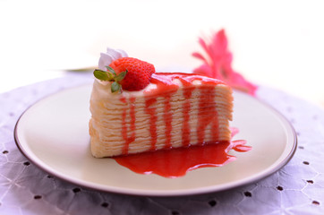 Crape cake with strawberry topping.