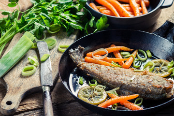 Freshly fried fish with lemon and parsley