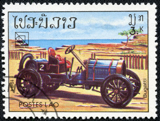 Fototapeta na wymiar stamp printed in Laos showing vintage car