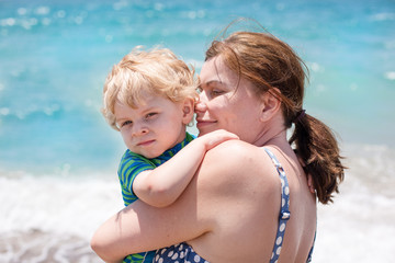Portrait of mother and her little son on the beach