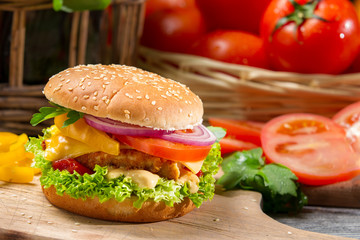 Closeup of hamburger with chicken, tomato and vegetables