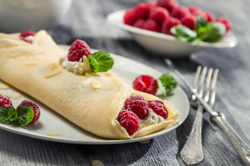 Strawberry pancakes sprinkled with icing sugar