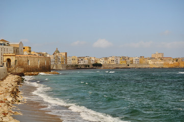 Fototapeta na wymiar A beautiful panorama showing the beautiful old town of Trapani in Sicily showing the golden old town walls and the blue sea and sky 