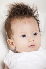 Portrait of newborn baby with funny hair