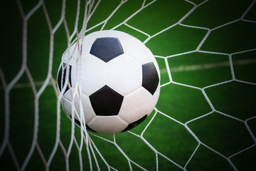 Fototapeta na wymiar football in goal net