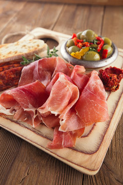 Platter of serrano jamon Cured Meat, Ciabatta, chorizo and olive