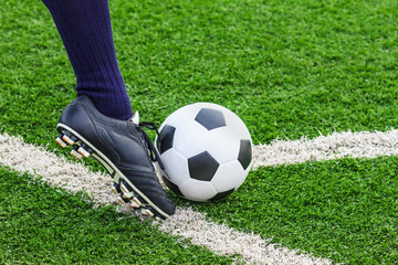 foot kicking soccer ball on corner