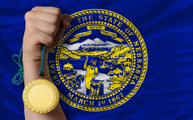 Gold medal for sport and  flag of american state of nebraska