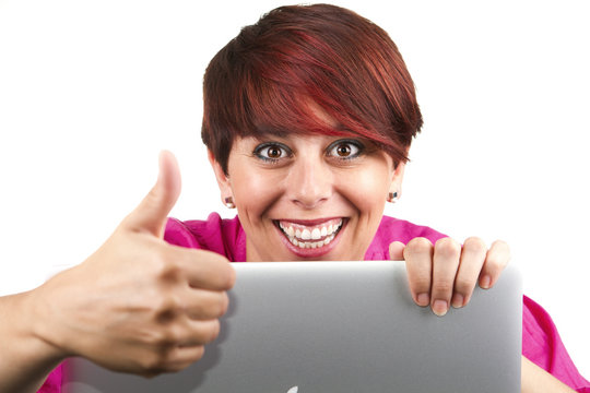 Woman using laptop and doing thumbs up