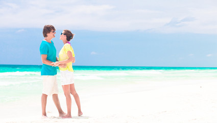 young couple walking on beach. honeymoon concept