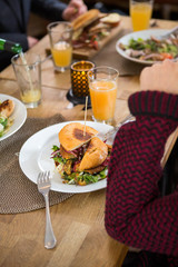 Young Woman With Burger In Plate