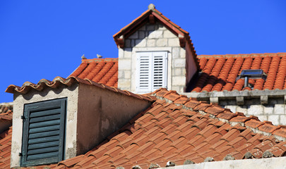 Terracotta roofs and dormer windows with shutters