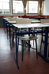 Fototapeta na wymiar Desk And Chairs In A Row At Classroom