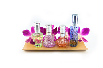 Obraz na płótnie Canvas Purple orchid and perfume bottles in bamboo dish