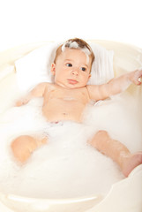 Quiet baby boy in water tub