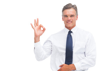 Mature businessman saying ok with hand