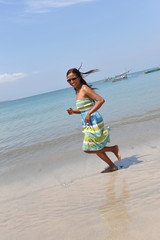 beautiful asian girl jogging on tropical beach