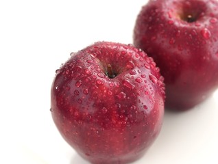 Wet red apple with water drop isolated on white background