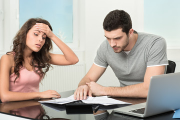 man upset after looking at card statement.