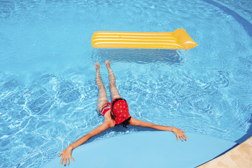 Young woman relaxing in the pool