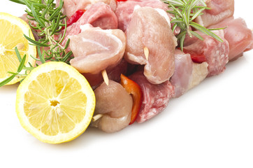 chicken skewers and rosemary close up on white