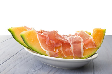 Ham and cantaloupe melon on the gray table