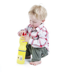 Infant playing with toxic bottle