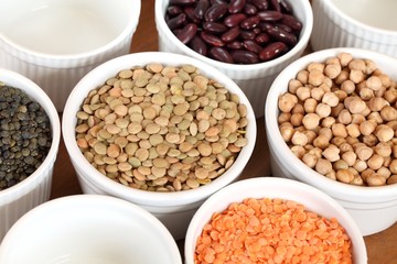 Bowls with different kinds of lentil, beans and chickpea.