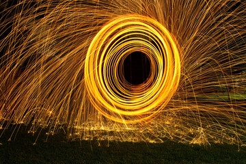 Burning steel wool spin in circles to make patterns