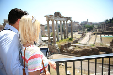 Couple of tourists using tablet by the Roman Forum