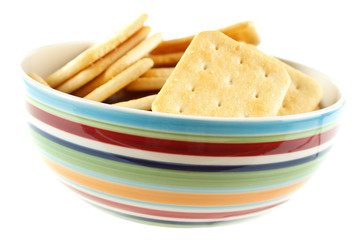 Saltine cracker snacks in bowl , isolated on white