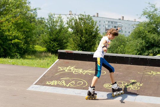 Teenage girl roller skating in a park