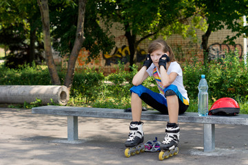 Young roller skater taking a rest