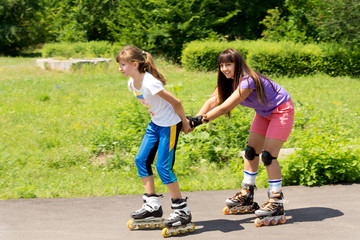 Two female friends roller skating