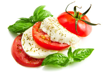 Fototapeta na wymiar Tomato and mozzarella with basil leaves