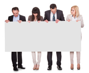 Portrait Of Businesspeople Group Holding Placard