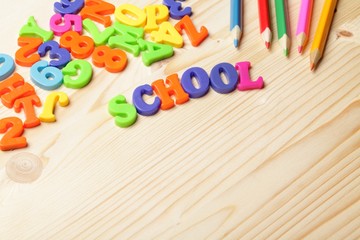 Colorful numbers and letters on wooden background