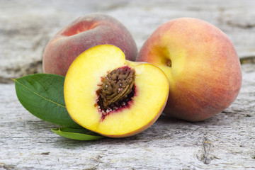 fresh peaches on old wooden background