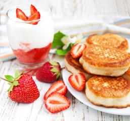 fresh strawberries  pancakes and yogurt