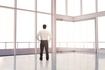 Fototapeta na wymiar Businessman standing in an empty room