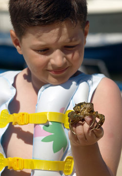 Boy with mud crab in hand