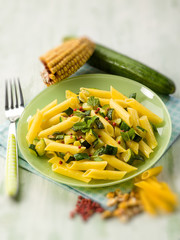 maize pasta with zucchinis and pink pepper, selective focus