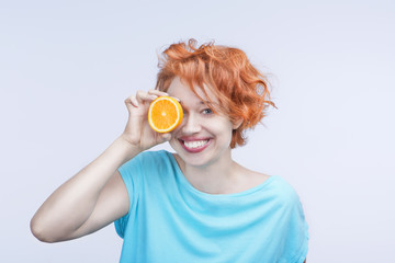 Bright smiling young woman with orange